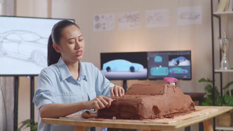 woman sculpting a car model