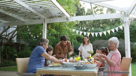 Family-eating-outside-together-in-summer