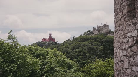 ancient stone wall remains and palace of pena in sintra, static distance view