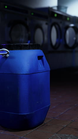 blue plastic barrel in a laundry room