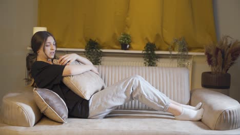 depressed young woman lying on the sofa.