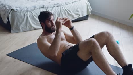 man doing crunches at home