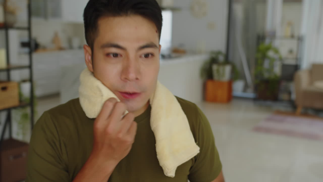 Sportsman Riding Fitness Bike and Drinking Water from Bottle