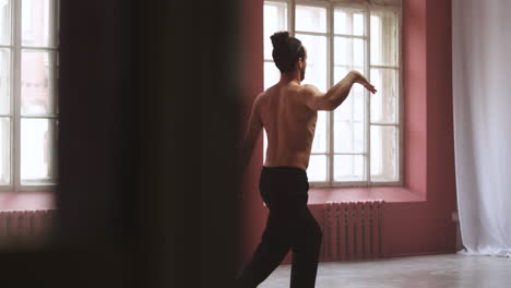 young man dancing in a classroom