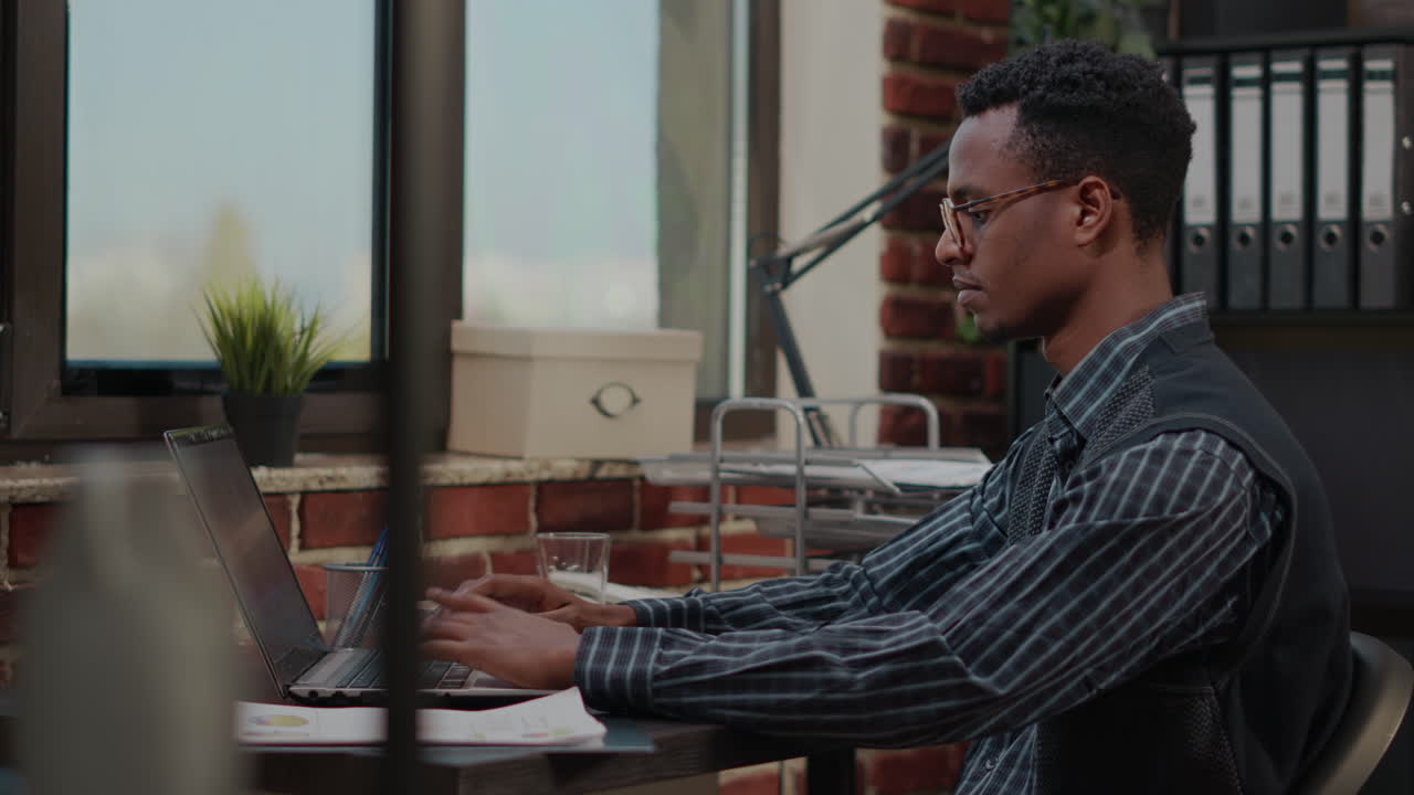 Accountant typing on laptop to do company management work