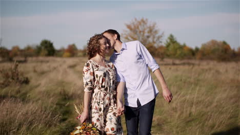 affectionate couple smiling in grassland
