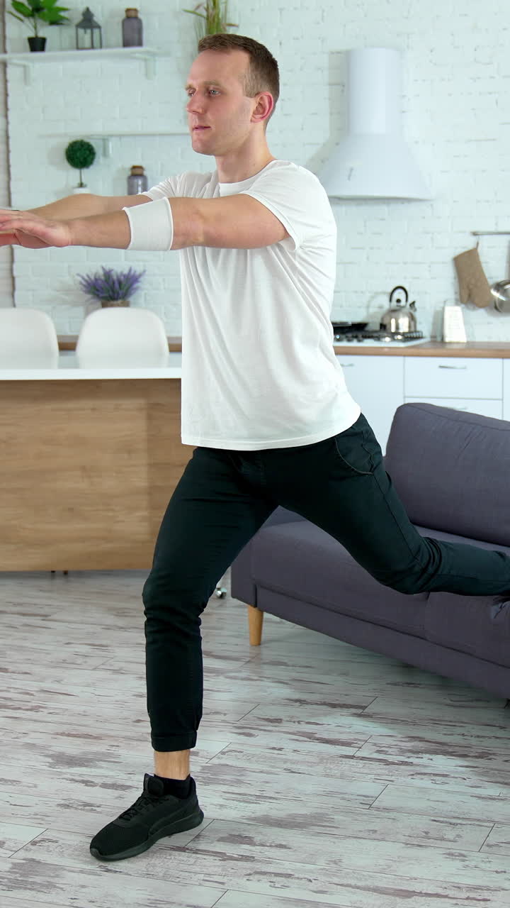 Sportsman doing morning fitness routine. Young man doing sports exercise at home. Vertical video