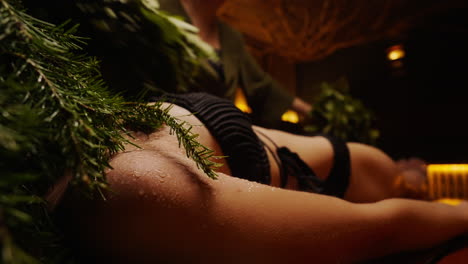 woman enjoying a herbal sauna treatment
