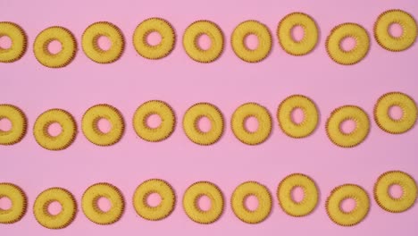 creative cookies pattern on pastel pink background. flat lay stop motion