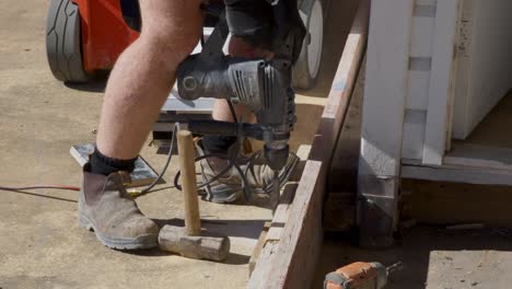 Man-with-a-hammer-drill,-drilling-into-concrete