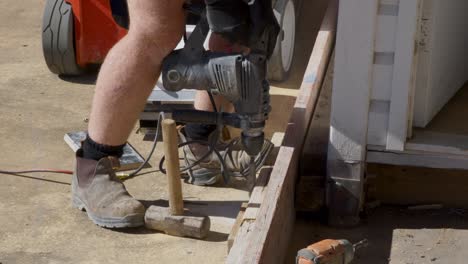 man with a hammer drill, drilling into concrete