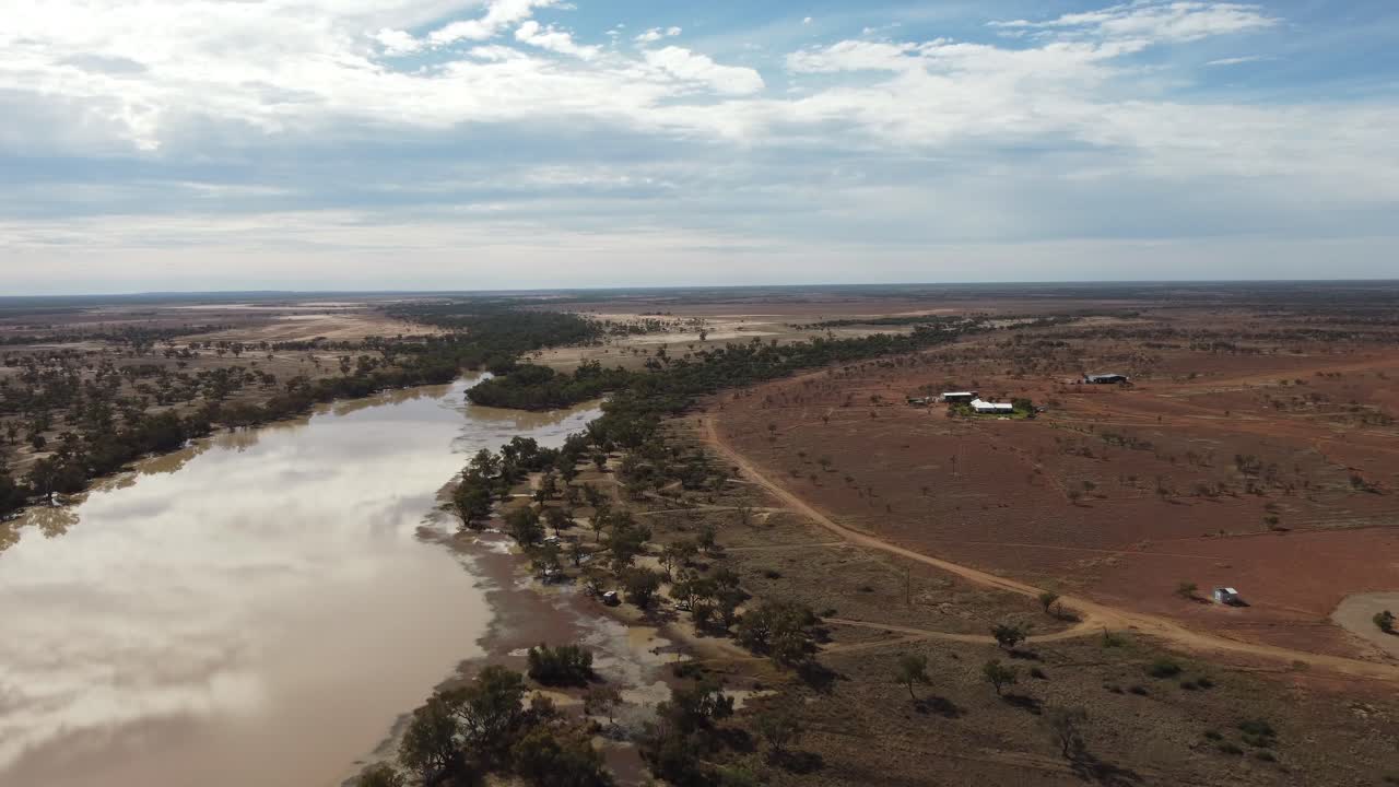 오스트레일리아의 외 ⁇ 에 있는 농장을 향해 호수 위를 날아다니는 드론