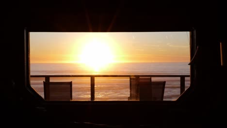 beach house looking at the sea through a window. sunset on the ocean