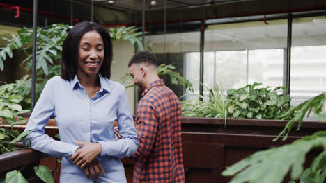 Portrait-of-happy-african-american-casual-businesswoman,-greeting-diverse-male-colleague-in-office