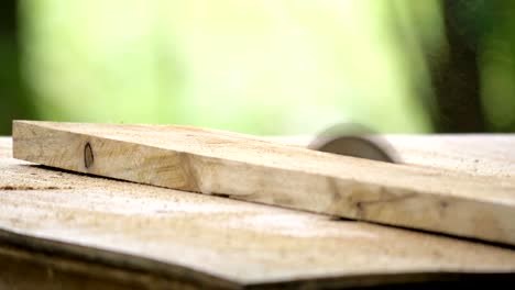 carpenter cutting wooden board with circular saw.