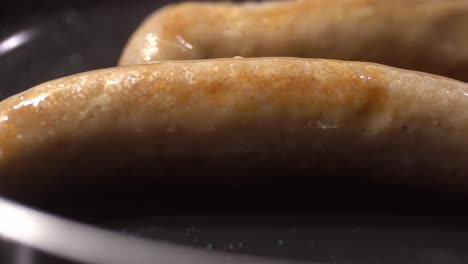 Closeup-shot-of-sauage-cooking-in-pan