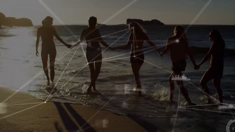 animación de la red de conexiones sobre amigas que se toman de la mano en la playa