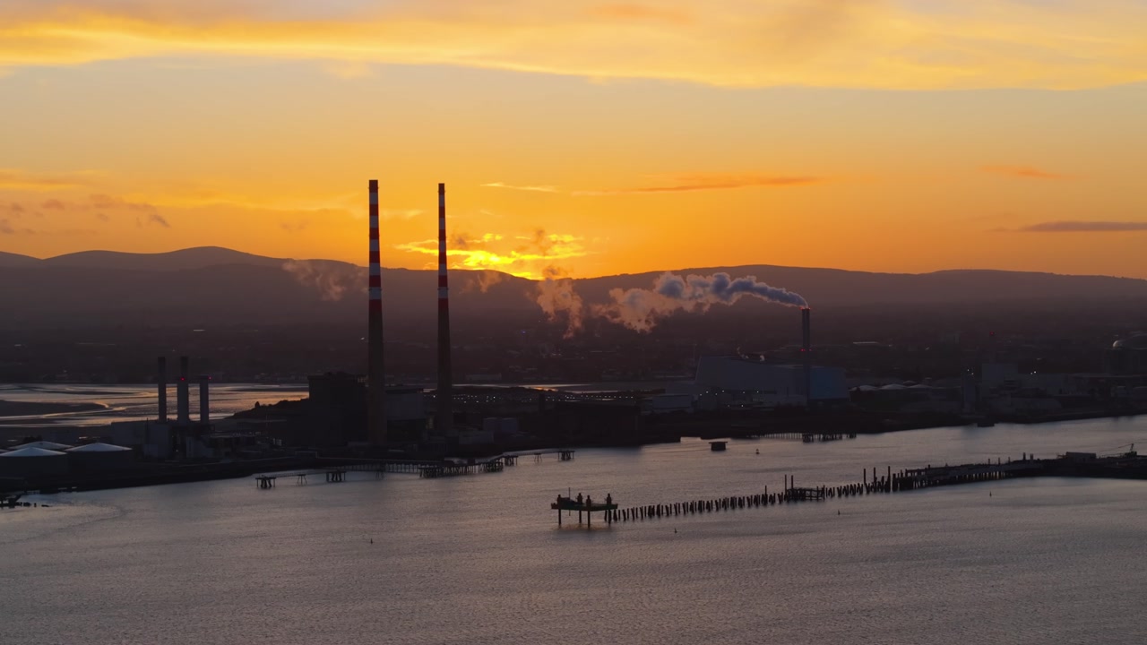 4K cinematic drone footage showcasing Poolbeg Lighthouse in Dublin during a breathtaking golden-hour sunset_15