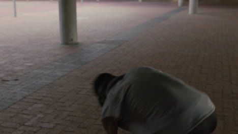 dancing man young mixed race breakdancer performing modern hip hop dance moves practicing urban freestyle choreography in city at sunset close up