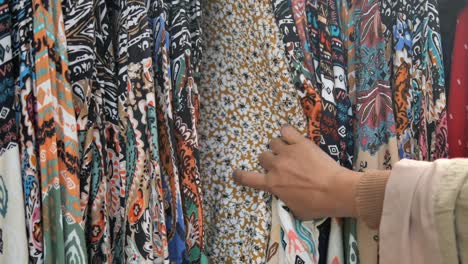 woman shopping for colorful patterned clothes