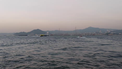 boats sailing towards stonecutters bridge near hong kong island in hong kong