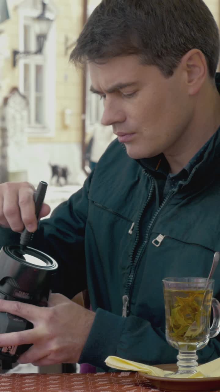 Man cleaning camera lens