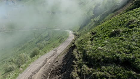 Auto-Fährt-An-Einem-Sonnigen-Tag-In-Georgien-Auf-Der-Unbefestigten-Straße-Des-Tskhratskaro-Passes-Durch-Nebel