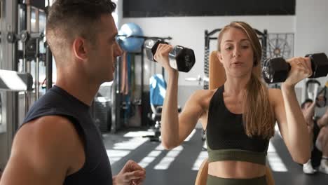 woman and personal trainer at the gym