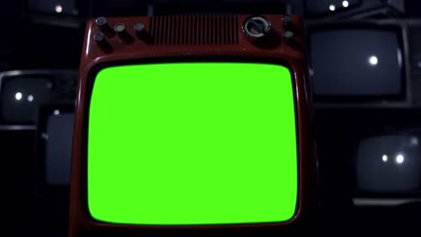 retro television turning on and off green screen among many retro tvs. dolly in. dark blue tone. 4k resolution.