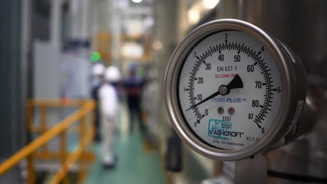 industrial pressure gauge in a factory setting