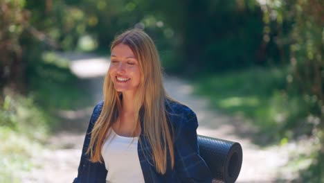 beautiful young blonde strolls smiling in nature