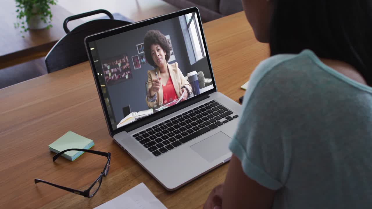 African american woman having a video call with female colleague on laptop
