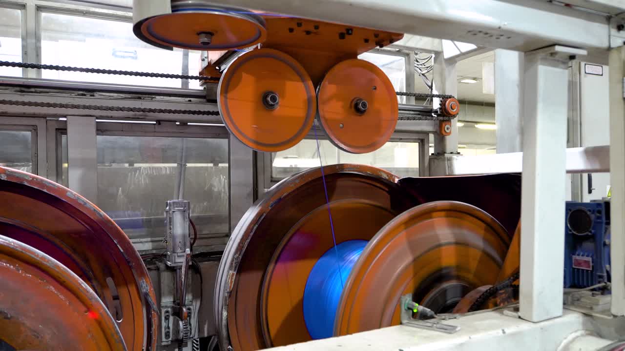 an electrical cable in isolation is wound on a metal coil