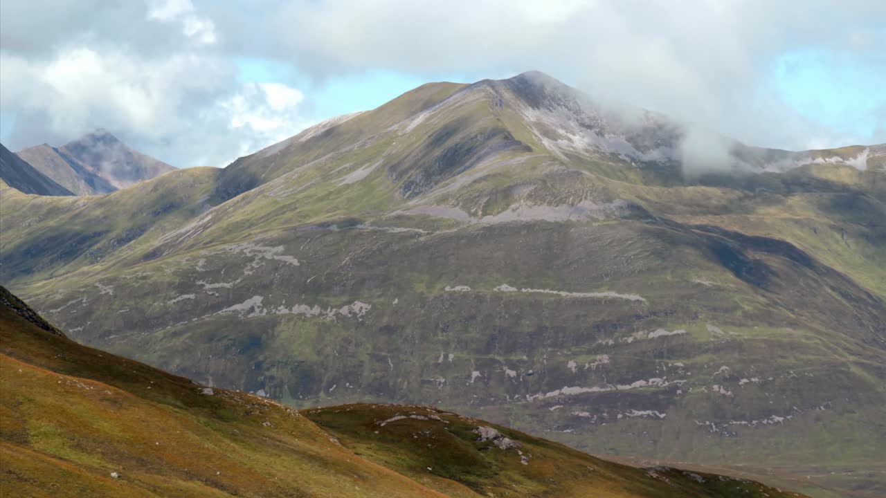 Timelapse of a partly sunny day in the Scottish highlands with scattered low hanging clouds
