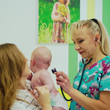 doctor examing baby with stethoscope