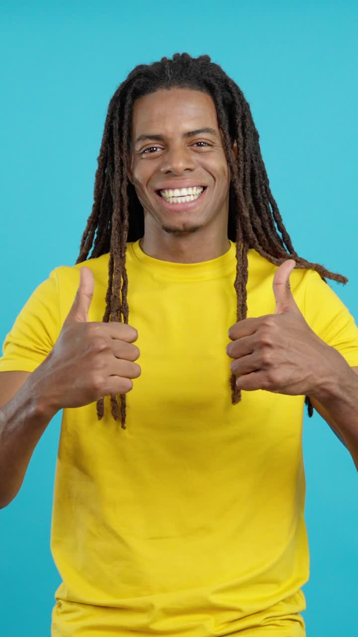 Man with dreadlocks giving thumbs up