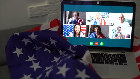 american-or-usa-national-flag.-working-from-home-on-computer-notebook-laptop-on-webcam-video-call-conference-in-quarantine.
