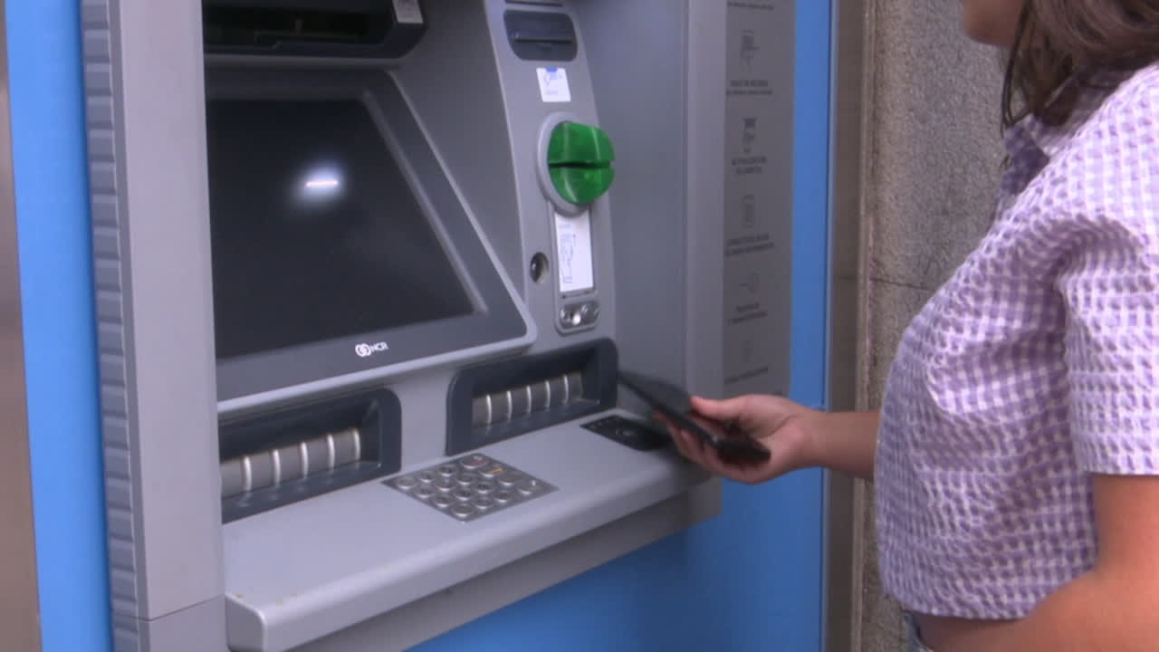 Woman using ATM