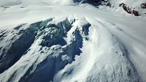 huge glacier in the swiss alps, with visible crevices