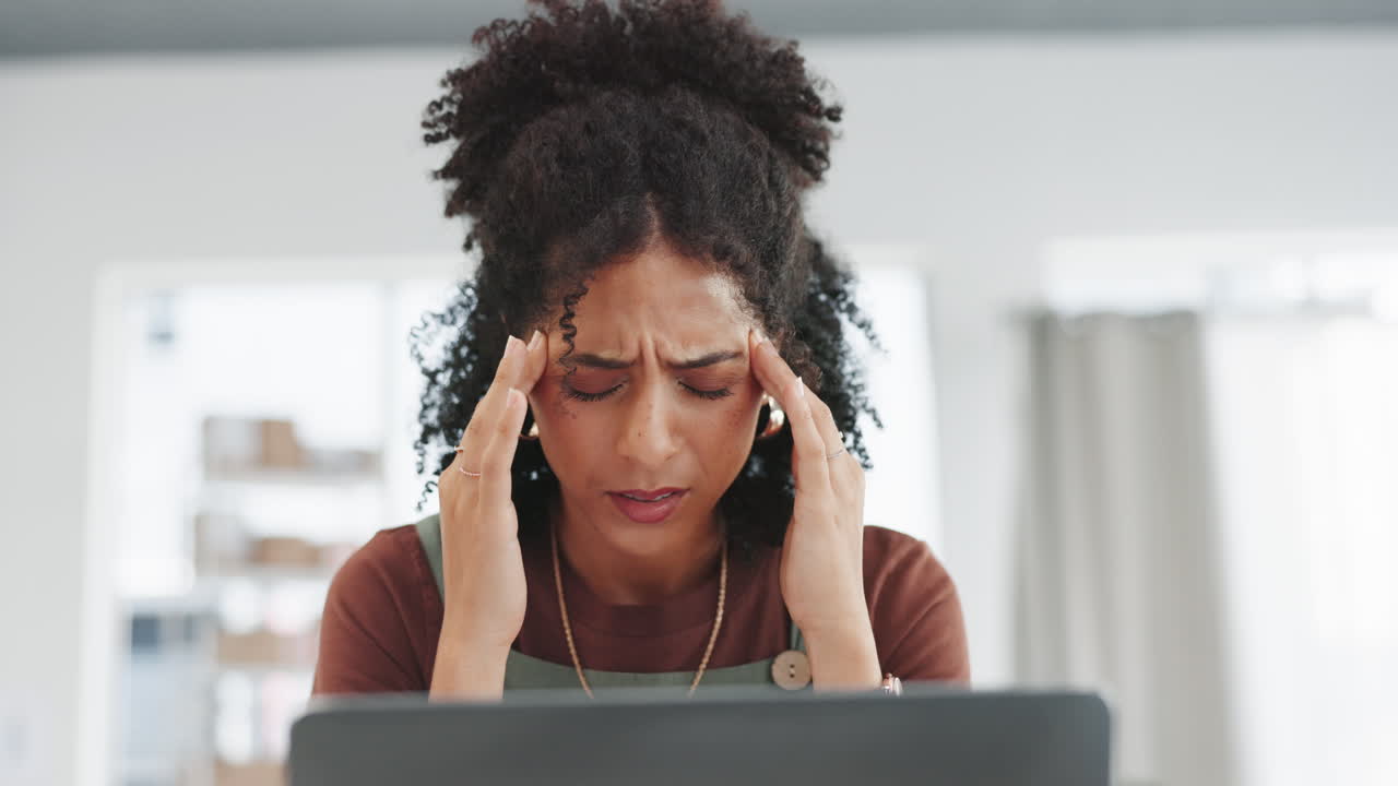 Woman, laptop and headache in burnout