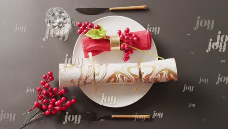 animation of christmas greetings text over christmas cracker and place setting with decorations