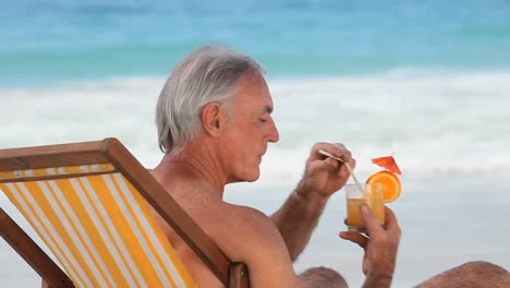 Elderly-man-sipping-a-cocktail