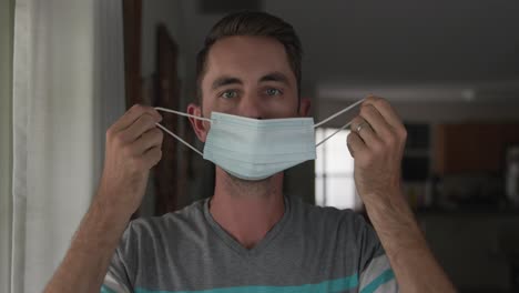 joven quitándose la máscara de pandemia de covid