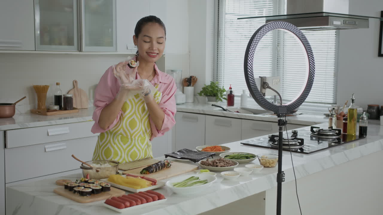 Gen Z Girl Showing Self-made Kimbap on Camera while Vlogging at Kitchen