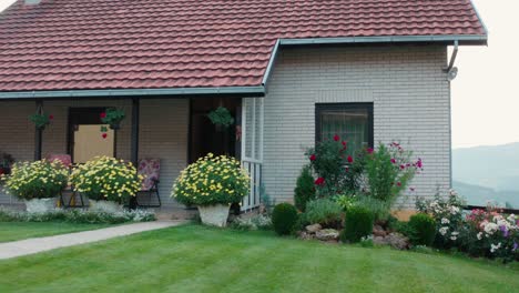 mountainside cottage house with beautiful spring garden, path to entrance