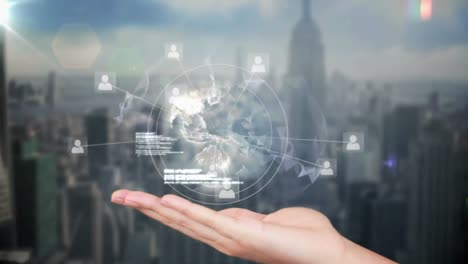 animation of profile icons and spinning globe over cupped hands against aerial view of cityscape