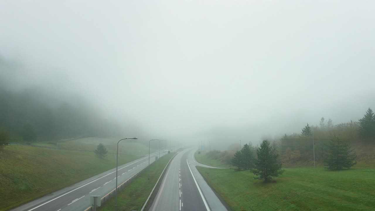 Cars pass through misty E18 highway in Norway's foggy landscape