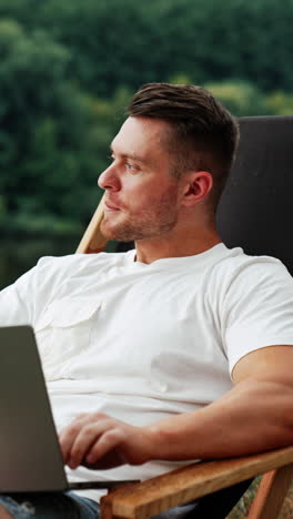 man working on laptop outdoors