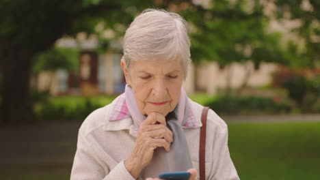 Senior-woman-with-phone-thinking