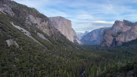 view over yosemite valley and el capitan pine forest during evening time pan right